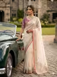Off white wedding saree with contrast purple blouse