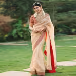 Gold organza saree with embroidery and red blouse