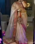 Gold organza saree with embroidery and red blouse